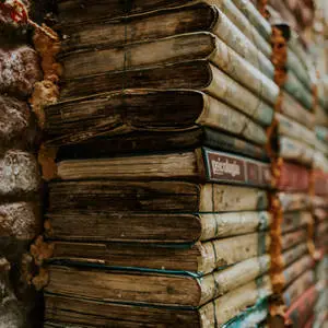 A Pile of Vintage Books in a Library